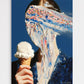 Person eating an ice cream cone with colorful sprinkles against a blue background