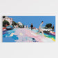 Colorful street with people and cars on a clear day