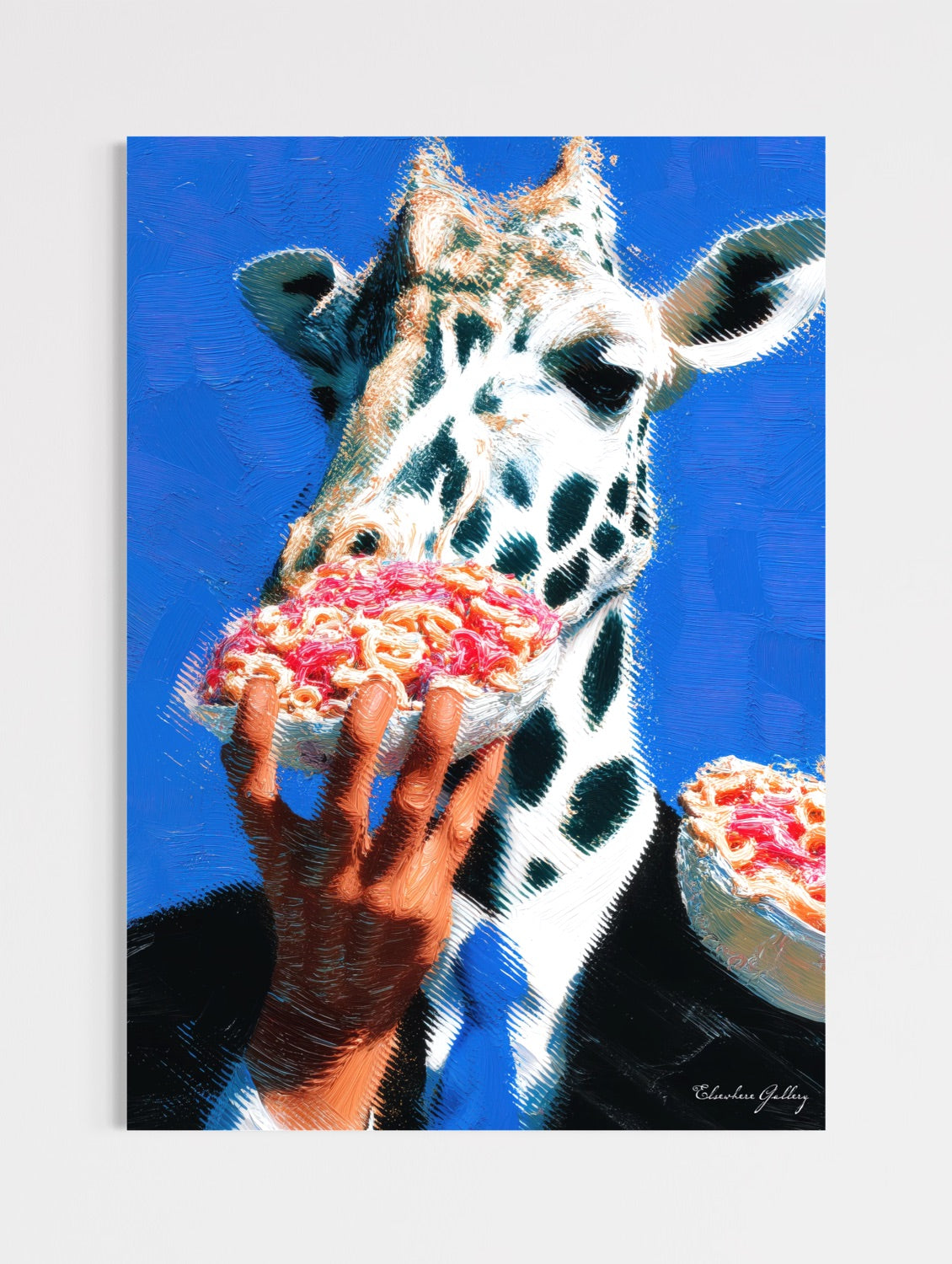 Giraffe eating a piece of pizza held by a hand against a blue background