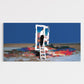 Man on a ladder painting a colorful landscape with an open door in the background