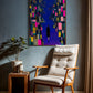 Modern interior with a chair, side table, and abstract painting on the wall.