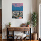 Room interior with a wooden console table, plants, and a colorful painting on the wall.