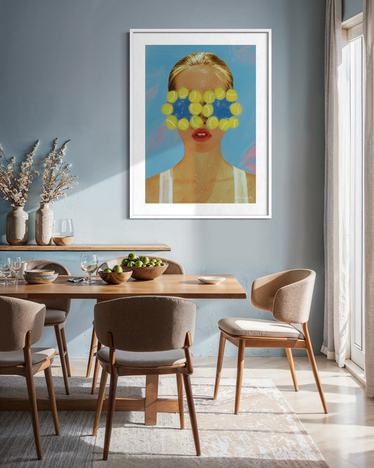 Dining room with a framed artwork on the wall, featuring a person with flowers covering their eyes.