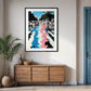 Framed artwork on a wall above a wooden sideboard in a room with a plant and door.