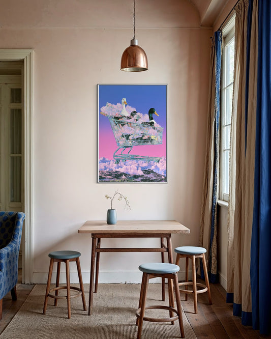 Room interior with a dining table and stools, colorful wall art, and a lamp.