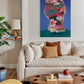 Living room with a colorful abstract painting above a beige sofa.