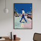 Framed artwork of a person walking on a street with cars in an urban setting, displayed in a room with a table and chair.