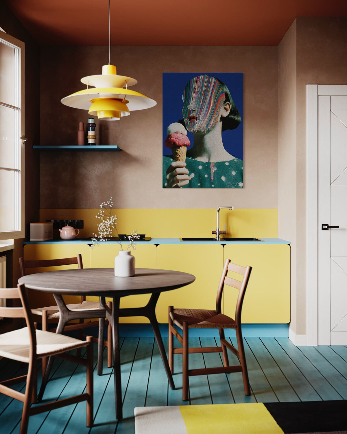 Modern kitchen with yellow cabinets, wooden table, and colorful wall art.