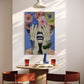 Dining area with a table, chairs, and a colorful floral painting on the wall.