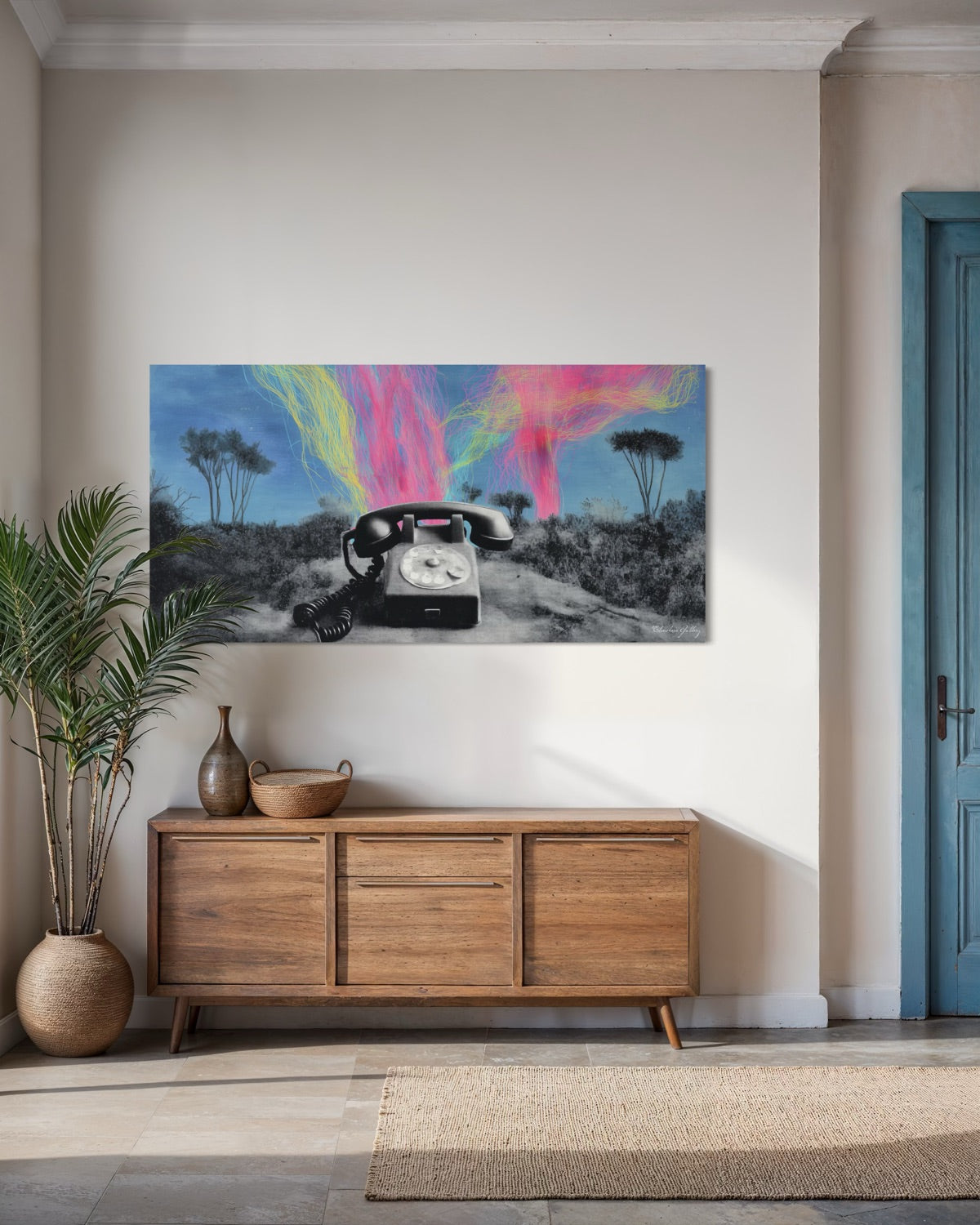 Modern interior with a wooden sideboard, decorative items, and a colorful abstract painting on the wall.