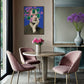 Dining room with pink chairs, round table, and abstract art on the wall.