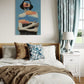 Bedroom with a bed, pillows, and a decorative wall art piece.