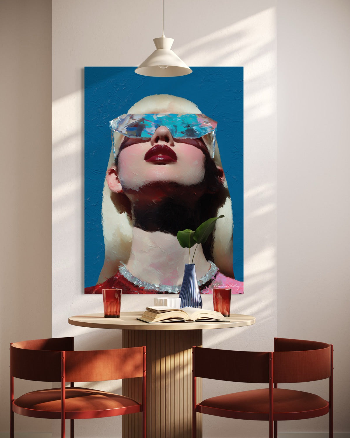 Modern interior with a large abstract painting of a woman's face on a wall above a dining table.