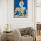 Modern interior with a textured armchair, side table, and abstract painting on the wall.