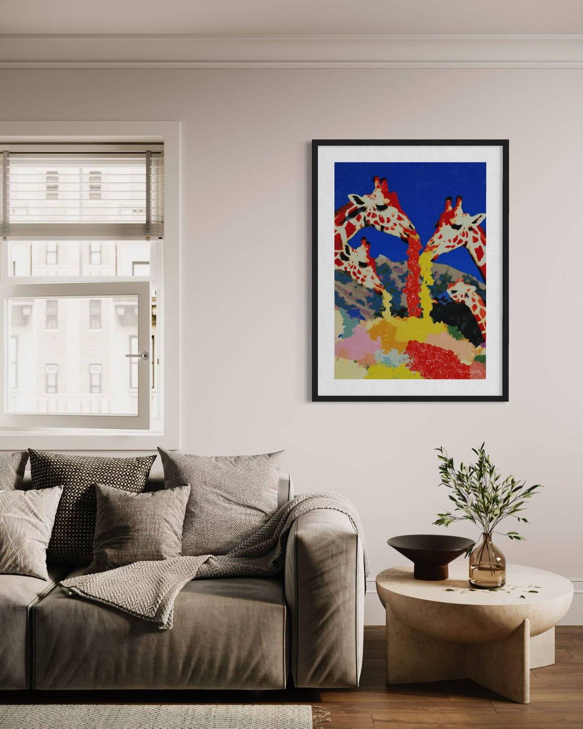 Living room with a sofa, coffee table, and colorful abstract art of giraffes on the wall.