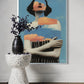 Framed artwork of a stylized woman with a vase and decorative elements on a table.