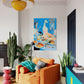 Living room with orange sofa, colorful rug, and abstract painting on the wall.