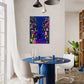 Modern dining room with a blue table and colorful abstract painting on the wall.