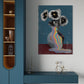 Abstract painting of flowers with a rainbow on a wall above a blue cabinet.