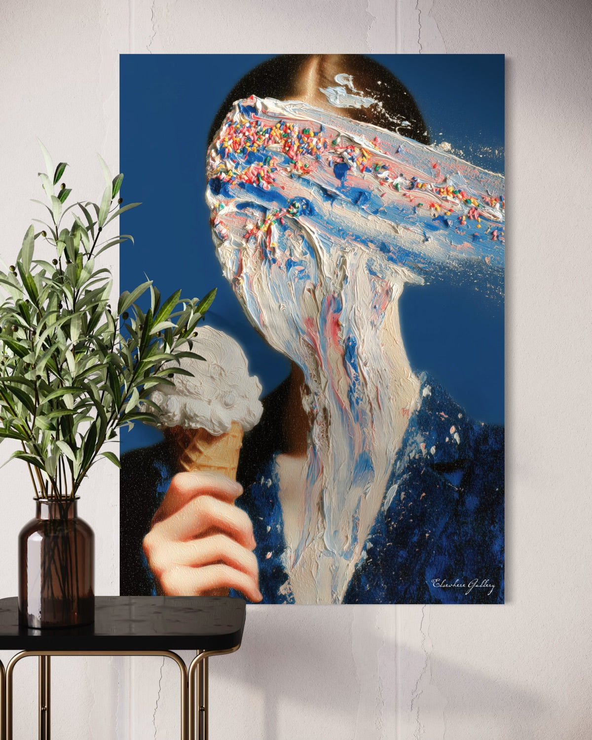 Abstract artwork of a person eating ice cream on a wall next to a plant.
