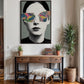 Modern interior with a framed artwork of a person wearing colorful sunglasses, a wooden console table, and decorative items.