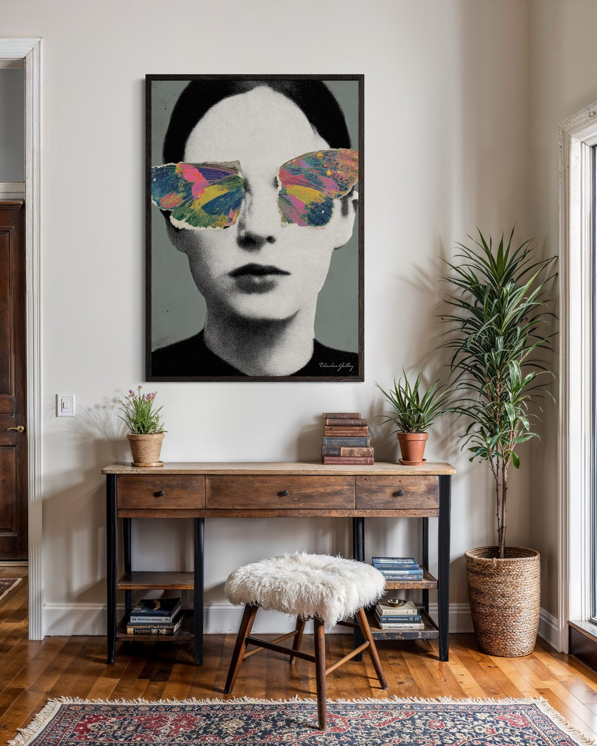 Modern interior with a framed artwork of a person wearing colorful sunglasses, a wooden console table, and decorative items.