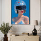 Framed artwork of a stylized woman with a colorful helmet on a wall above a cabinet.