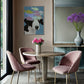 Dining room with pink chairs, round table, and decorative elements.