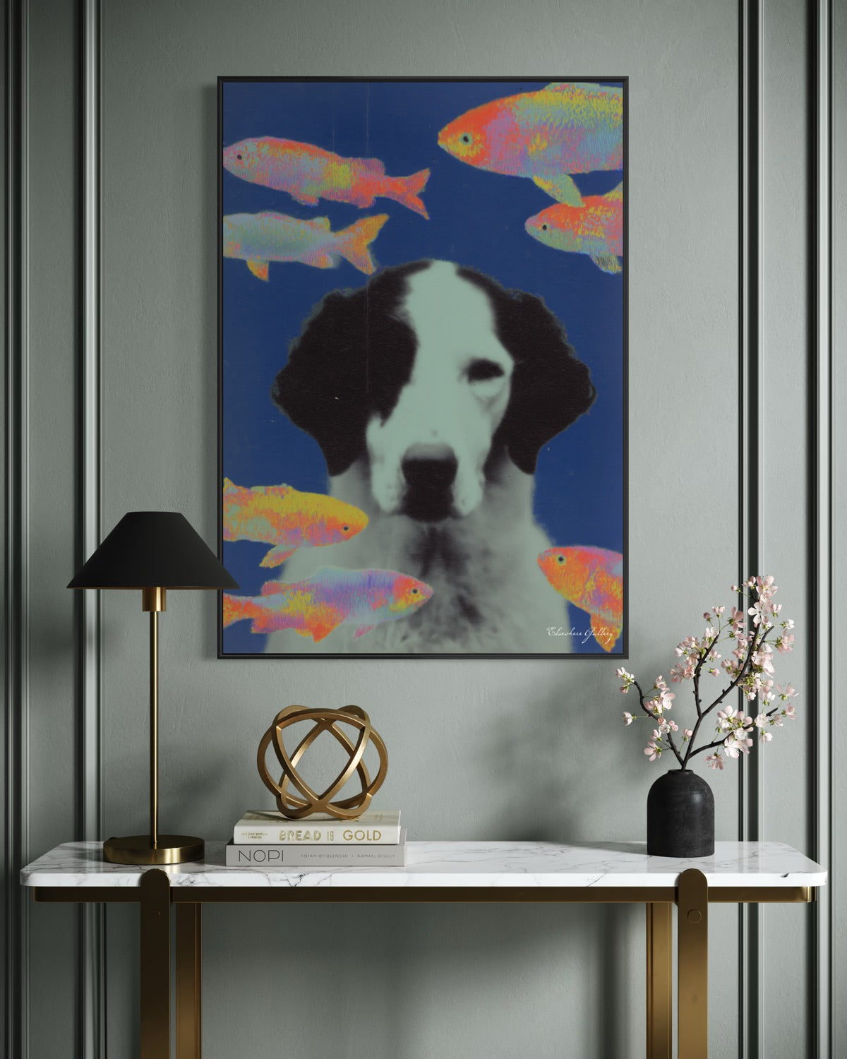 Framed artwork of a dog with colorful fish on a wall above a console table.