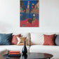 Living room with a white sofa, colorful pillows, a black coffee table, and a vibrant painting on the wall.