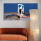Modern interior with a colorful abstract painting, orange sofa, and tall floor lamp.