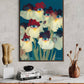 Framed abstract artwork of flowers with blue eyes on a wall above a wooden cabinet.