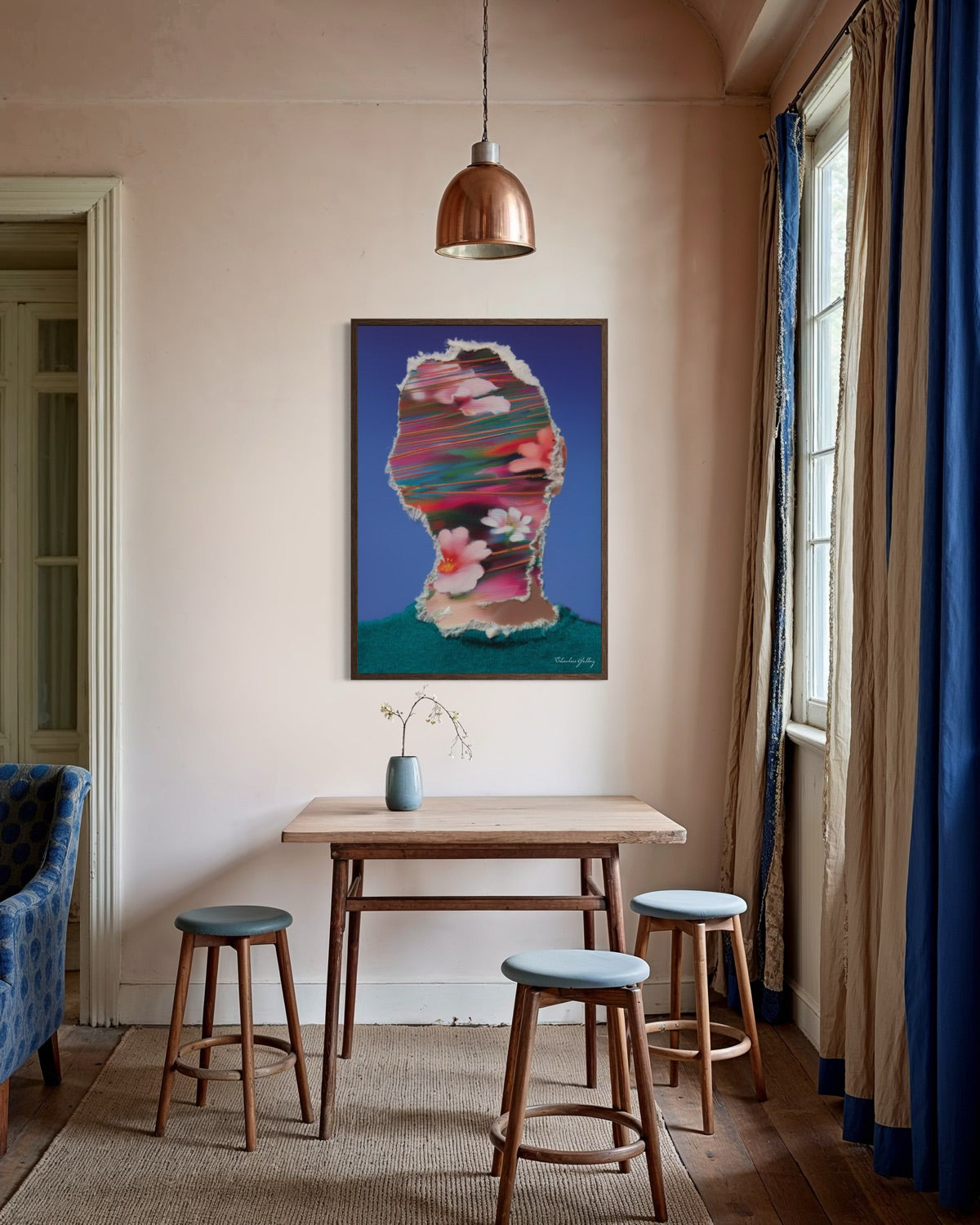 Room interior with a colorful abstract painting on the wall, wooden table, and stools.