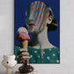 Framed artwork of a woman with a colorful face holding an ice cream cone on a white wall.