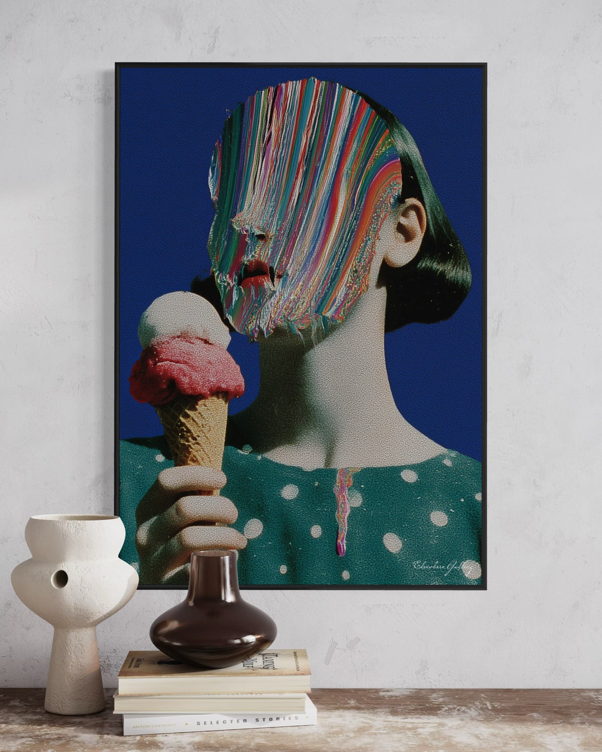 Framed artwork of a woman with a colorful face holding an ice cream cone on a white wall.
