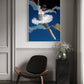 Modern interior with a chair, side table, and abstract painting on the wall.