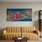 Living room with a yellow sofa, round wooden coffee table, and a large painting of a city street scene on the wall.