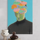Abstract art print of a person with colorful flowers replacing their head on a blue background, displayed on a wall above books and vases.