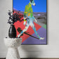 Colorful abstract painting of a dog on a wall above a white pedestal with a black vase.