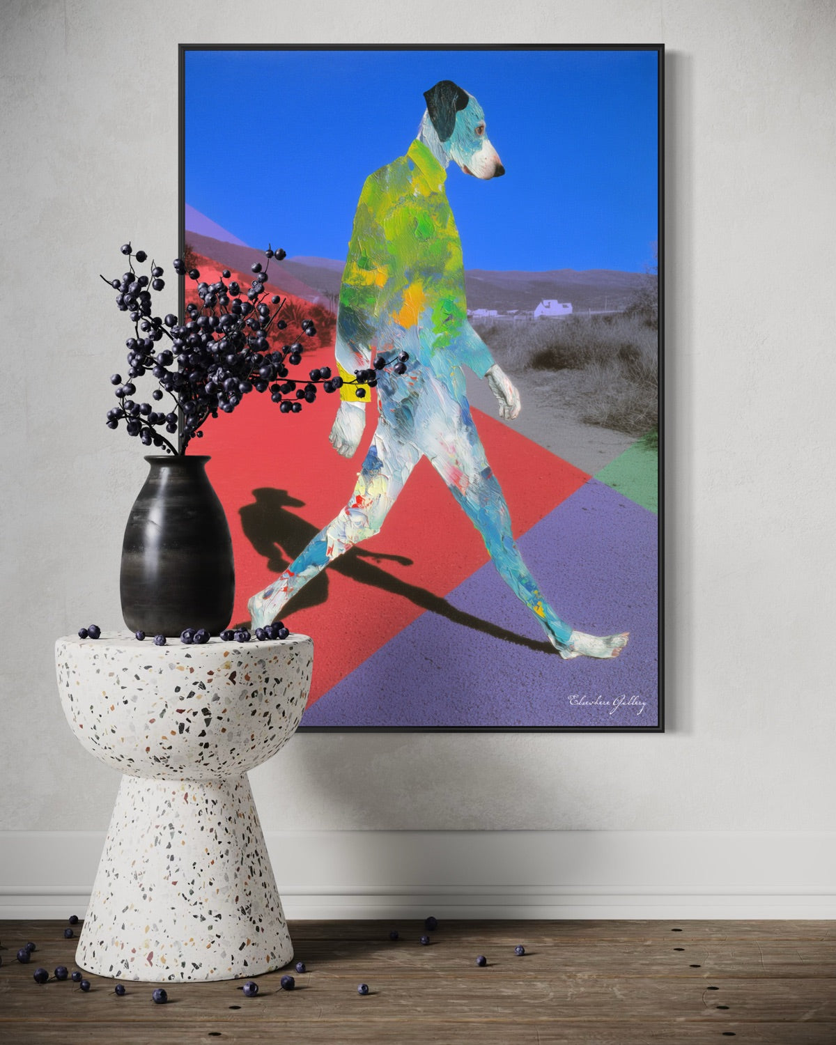 Colorful abstract painting of a dog on a wall above a white pedestal with a black vase.