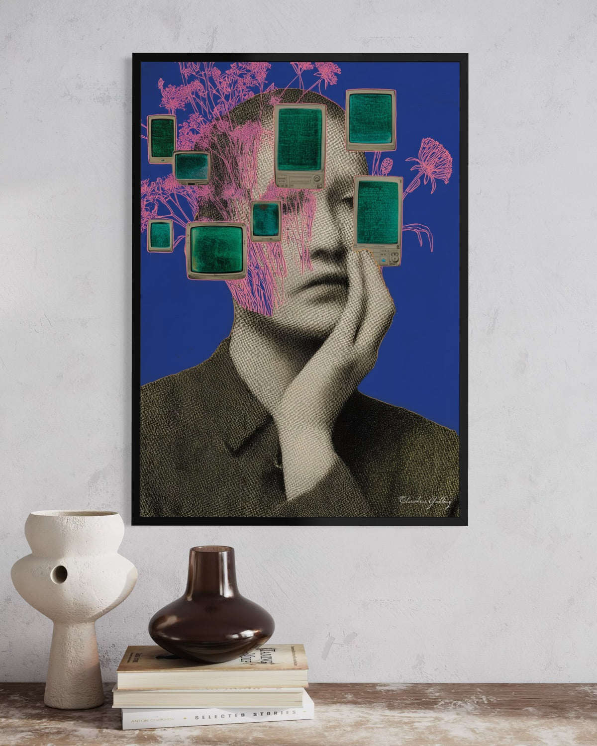 Collage art piece with a person's face and abstract elements on a blue background, displayed on a wall above books and vases.