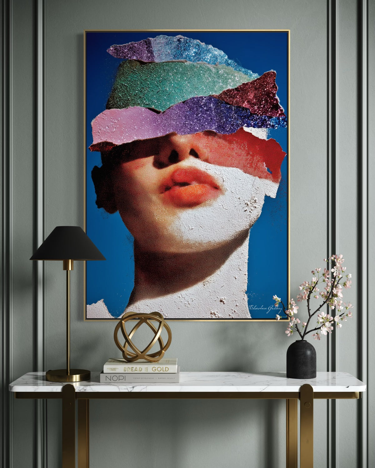 Colorful abstract art piece on a wall above a marble console table with decorative items.