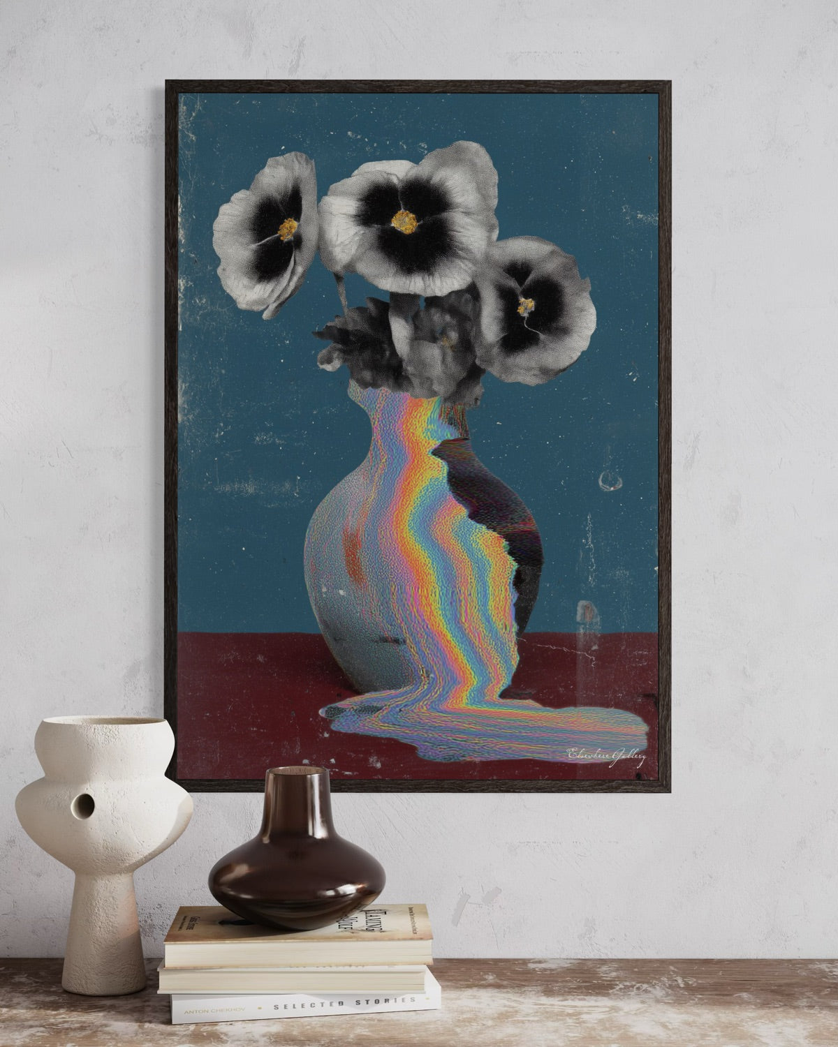 Framed abstract art of flowers and a vase with a rainbow effect on a wall.