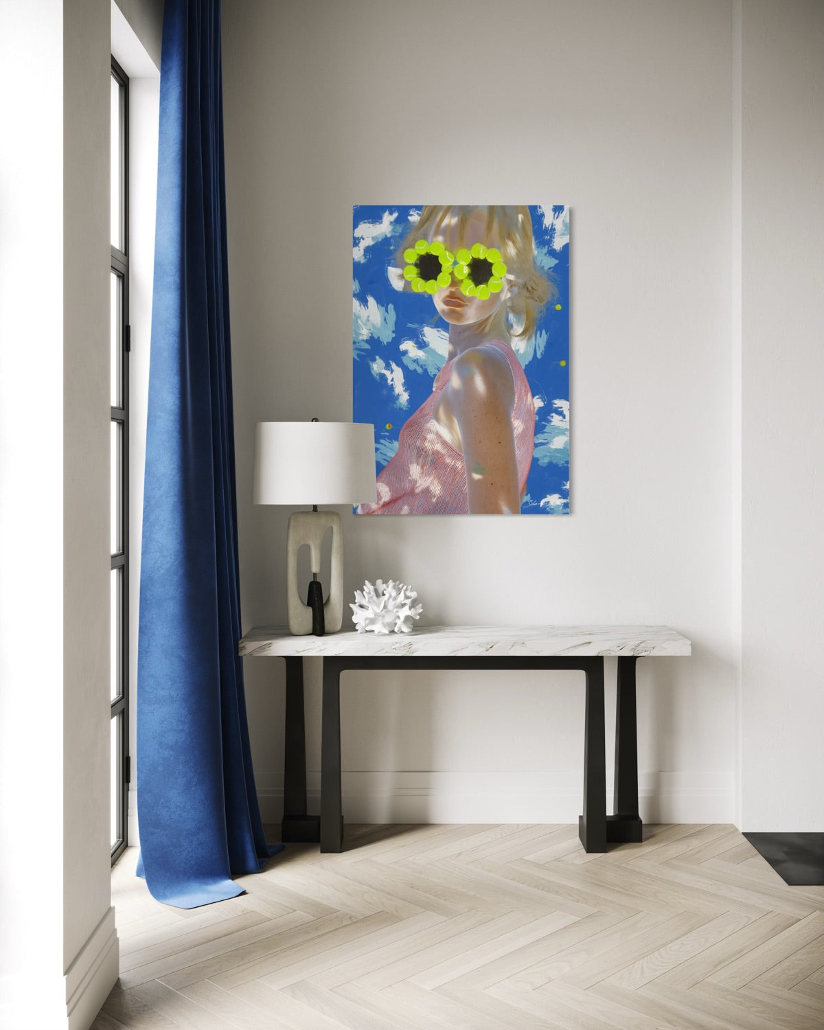 Modern interior with a painting of a person wearing sunglasses on a wall, a lamp, and a console table.