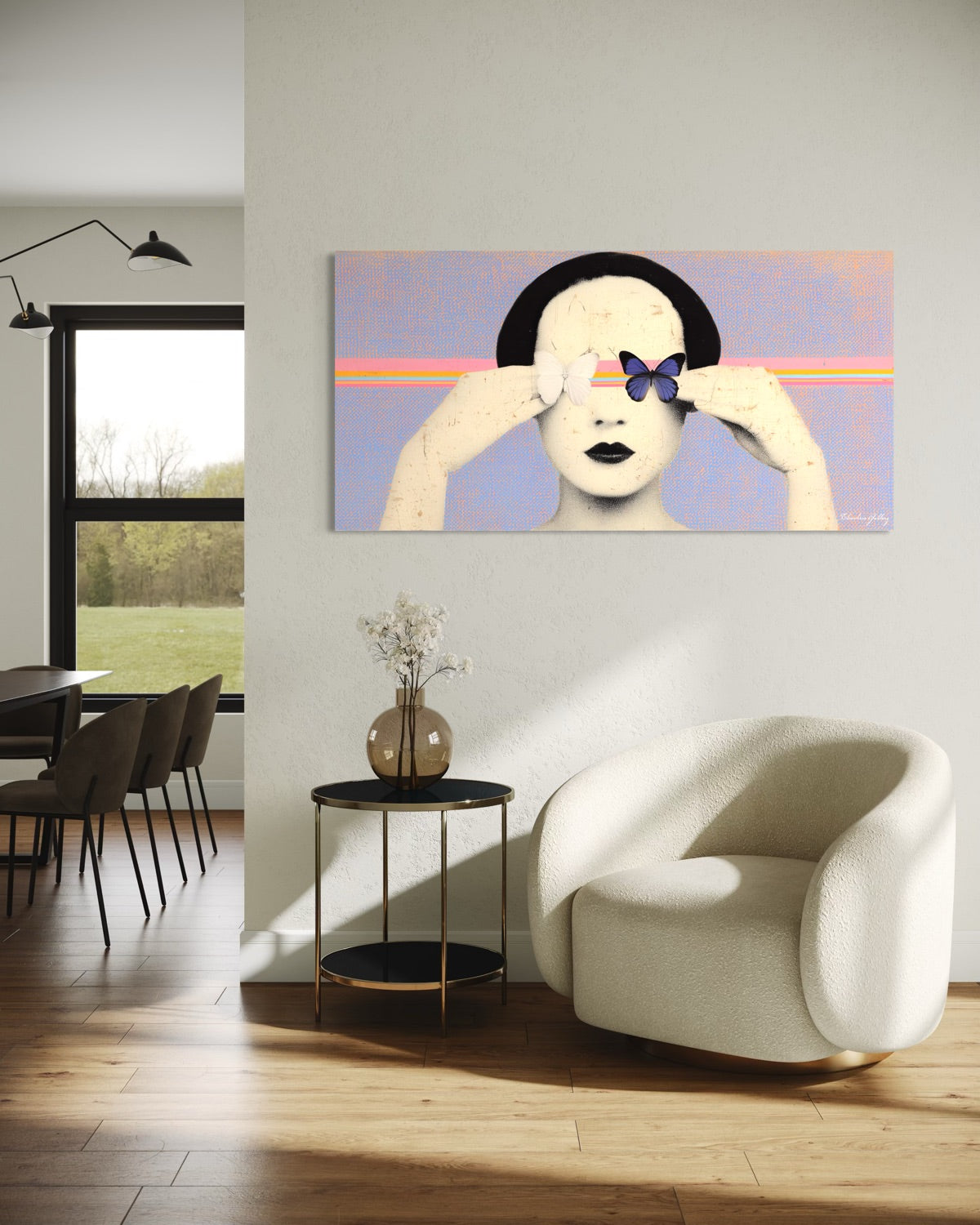Modern living room with a white armchair, side table, and abstract painting on the wall.