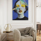 Modern interior with a textured armchair, side table, and abstract art on the wall.