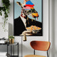 Framed artwork of a giraffe in a suit holding a bowl of cereal in a modern interior setting.