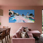 Modern living room with pink walls, a pink sectional sofa, and a colorful abstract painting.