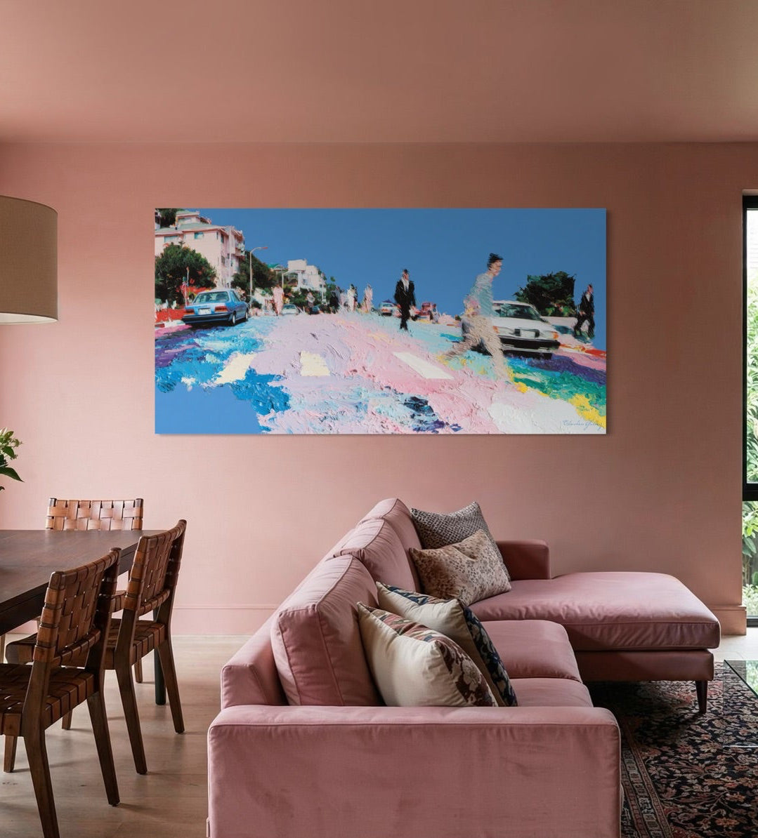 Modern living room with pink walls, a pink sectional sofa, and a colorful abstract painting.