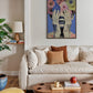 Living room with a beige sofa, wooden coffee table, and colorful wall art.